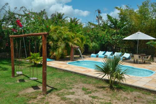 a backyard with a swing and a pool at Chacara Maluco Beleza 2 in Gravatá