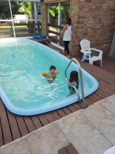 un niño y una niña jugando en una piscina en Departamentos en Pinamar en Pinamar