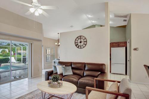 a living room with a couch and a table at SUPERB VILLA WITH PRIVATE POOL IN NAPLES in Naples