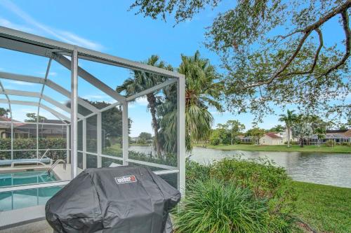 a glass house with a view of a body of water at SUPERB VILLA WITH PRIVATE POOL IN NAPLES in Naples