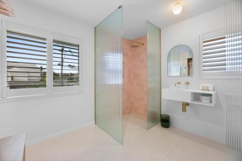 a bathroom with a shower and a sink and a mirror at Mediterranean Surfers Paradise Townhouse with BBQ in Gold Coast