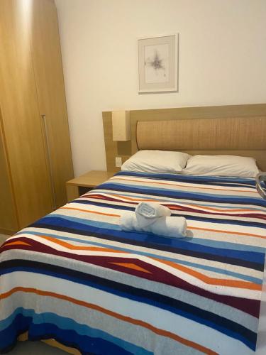 a bed with two stuffed animals on top of it at Flat Beach Class Resort Muro Alto in Porto De Galinhas