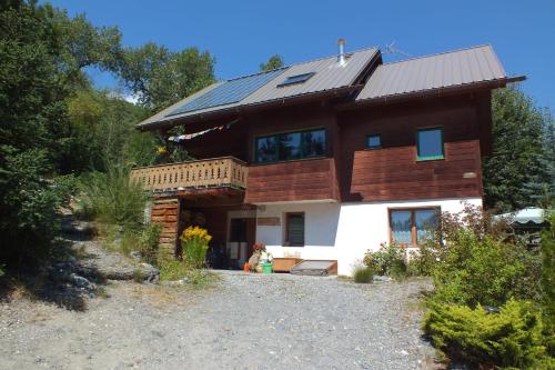 a house with a solar roof on top of it at Le Clos du Vas - Puy Saint André in Puy-Saint-André
