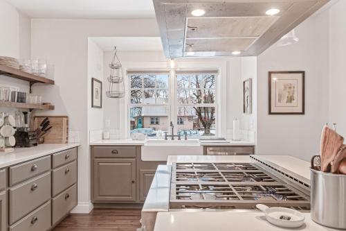 a kitchen with white walls and a large window at Blue Moose Downtown Home in Sandpoint