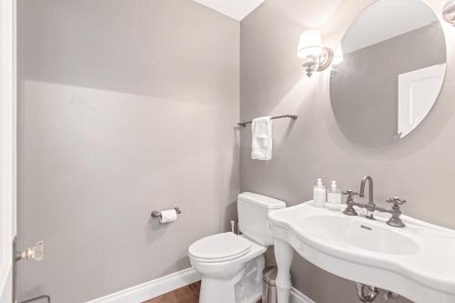 a white bathroom with a toilet and a sink at Blue Moose Downtown Home in Sandpoint