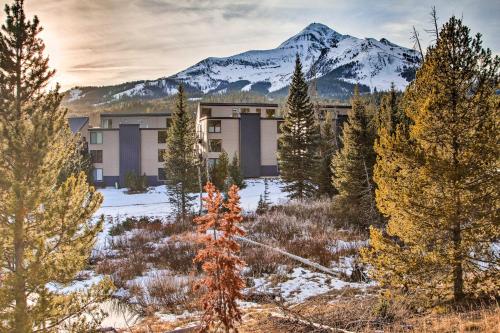 a building with a snow covered mountain in the background at Cozy Big Sky Studio about 1 Mile to Mtn Village! in Big Sky