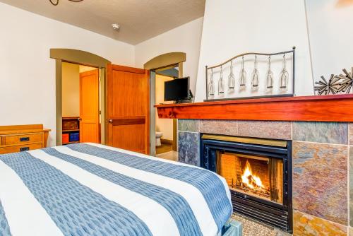 a bedroom with a bed and a fireplace at Honeycomb House in Solitude