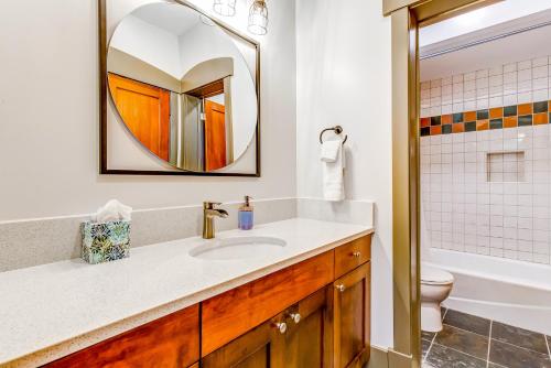 a bathroom with a sink and a toilet and a mirror at Honeycomb House in Solitude