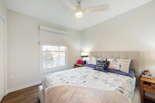 a bedroom with a bed with a ceiling fan at Sea Colony - 19006 Lakeview Court in Bethany Beach