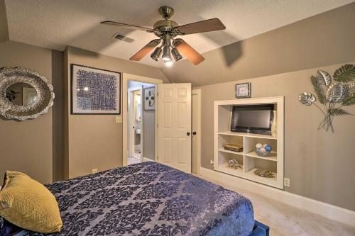 a bedroom with a ceiling fan and a bed at Cozy Conyers Cabin with Fireplace and Pool Table! in Conyers