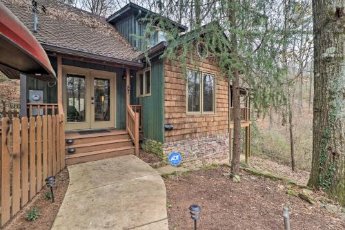 a small house with a porch and a fence at Cozy Conyers Cabin with Fireplace and Pool Table! in Conyers