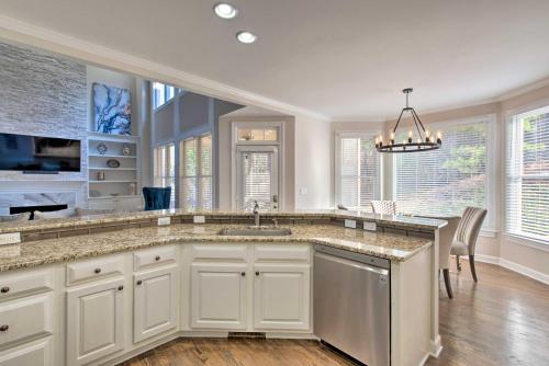 a kitchen with white cabinets and a large island at Updated Mableton Home about 14 Miles to Downtown ATL! in Mableton
