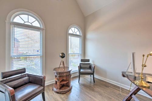 a living room with a couch and a chair and two windows at Updated Mableton Home about 14 Miles to Downtown ATL! in Mableton