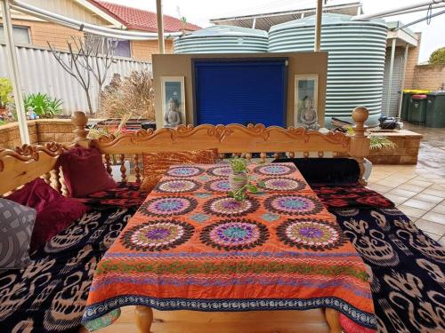 a table with a quilt on top of it at Spacious Holiday Home - Waikerie in Waikerie