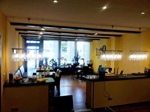 a restaurant with a bar and a dining room at Hotel an der Uffe in Bad Sachsa