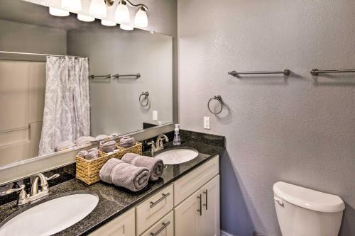 a bathroom with two sinks and a mirror at Home Grassy Yard, Walk to Bentonville Square in Bentonville