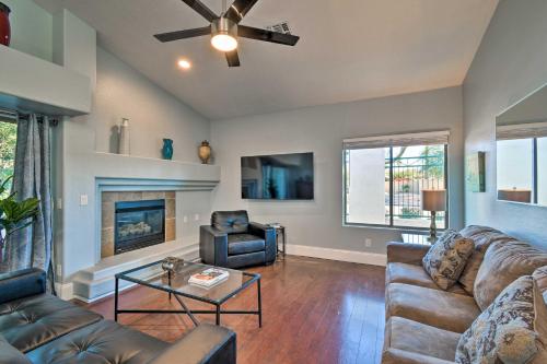 a living room with a couch and a fireplace at 6 Mi to Downtown Condo with Patio in Tempe! in Tempe