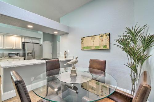 a dining room with a glass table and chairs at 6 Mi to Downtown Condo with Patio in Tempe! in Tempe