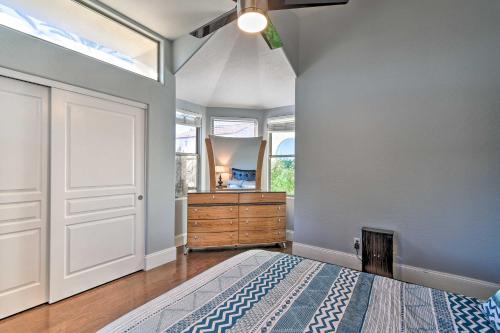 a bedroom with a bed and a dresser and a mirror at 6 Mi to Downtown Condo with Patio in Tempe! in Tempe