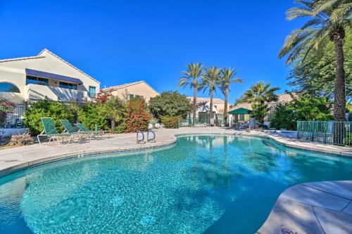 a large swimming pool in a yard with palm trees at 6 Mi to Downtown Condo with Patio in Tempe! in Tempe