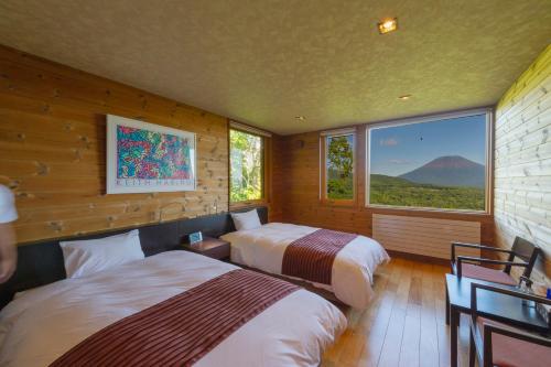 Tempat tidur dalam kamar di Niseko HyKrots IKIGAI Village
