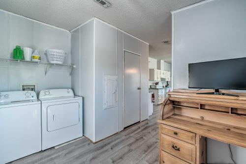 a laundry room with a washer and dryer and a tv at 5 Mi to Homosassa Springs Park Home with Yard! in Homosassa