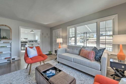 a living room with a couch and a chair at Mid-Century Modern Cottage in Ardmore Area! in Winston-Salem
