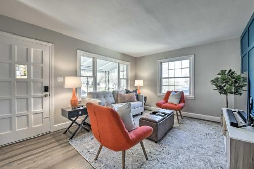 a living room with a couch and a table and chairs at Mid-Century Modern Cottage in Ardmore Area! in Winston-Salem
