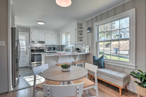 a kitchen and dining room with a table and chairs at Mid-Century Modern Cottage in Ardmore Area! in Winston-Salem