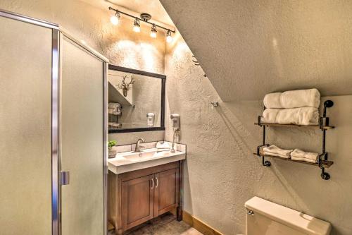 a bathroom with a sink and a shower and a mirror at Ski-InandSki-Out Granby Ranch Retreat with Mtn View! in Granby