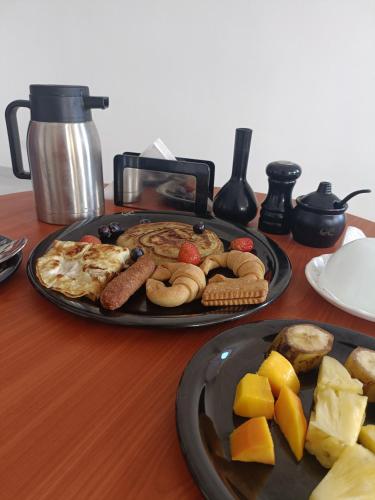 a table topped with a plate of breakfast food at City Centre in Mombasa