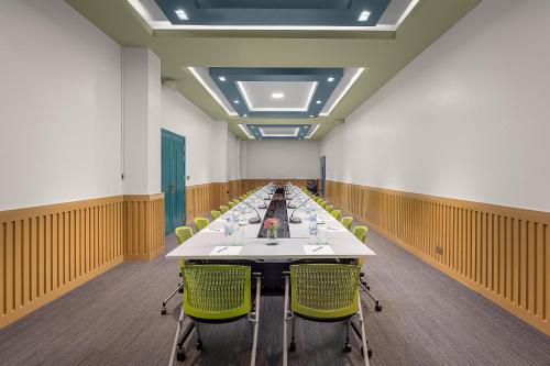 a long conference room with a long table and chairs at Vakara Hotel Kep in Kep