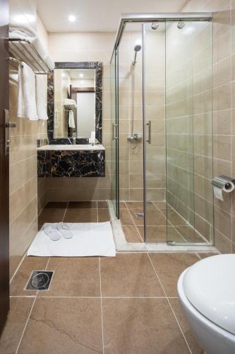 a bathroom with a shower and a sink at Mirada Purple Zahra - Serviced Apartments in Jeddah