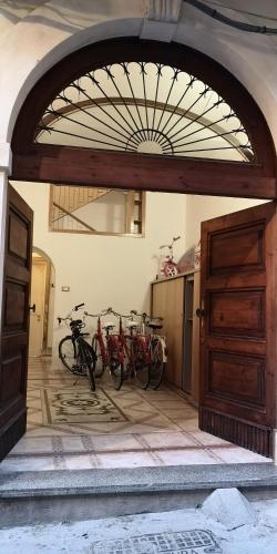 two bikes parked in a room with an open door at SEA-VIEW TERRACE & BIKES Moon Ortigia Holiday Home in Siracusa