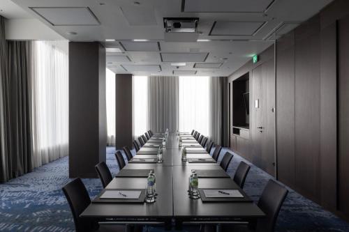 a long room with a long table and chairs at InterContinental - Ljubljana by IHG in Ljubljana