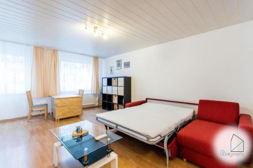 sala de estar con cama y sofá rojo en Modern apartment in central spot en Berlín