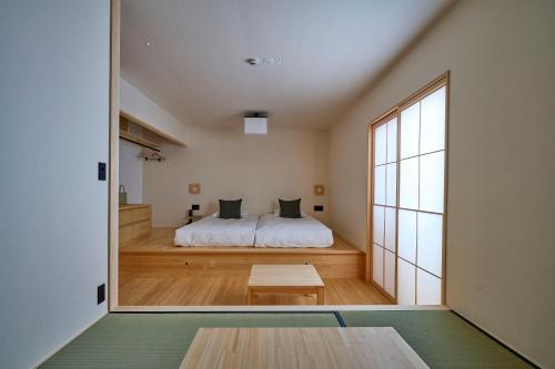 a bedroom with a bed and a large window at yubune in Onomichi