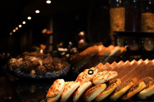 a bunch of hot dogs on a table with other foods at Seas Hotel Amman in Amman