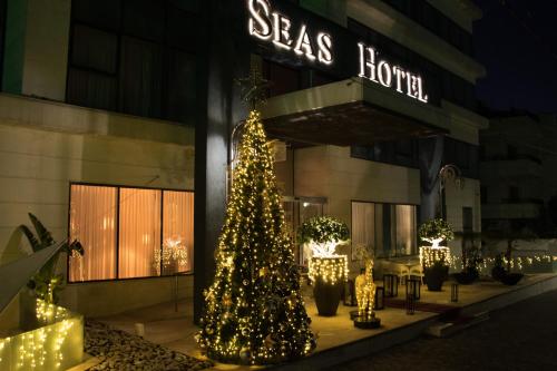 a christmas tree in front of a building at Seas Hotel Amman in Amman
