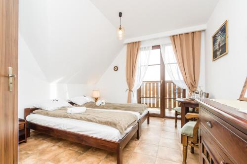 Кровать или кровати в номере Dom Podróżnika