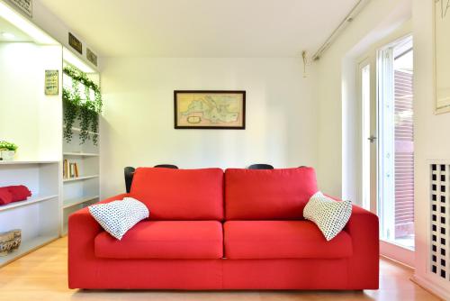 a red couch in a living room with a window at Appartamento Piazza Navona in Rome