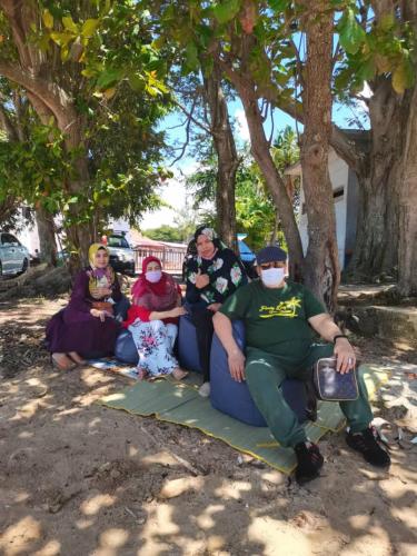 a group of people sitting on a couch under a tree at EHSAN SEAVIEW HOTEL PORT DICKSON in Port Dickson