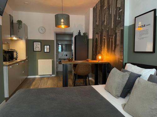 a bedroom with a bed and a kitchen with a table at Belle Histoire Middelburg in Middelburg
