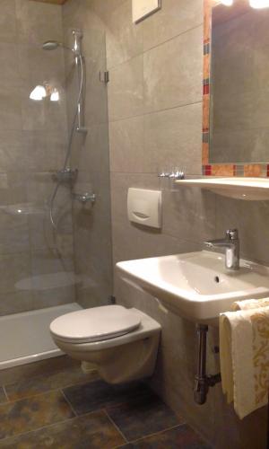 a bathroom with a toilet and a sink and a shower at Ferienwohnungen Fahringer Diana in Kössen