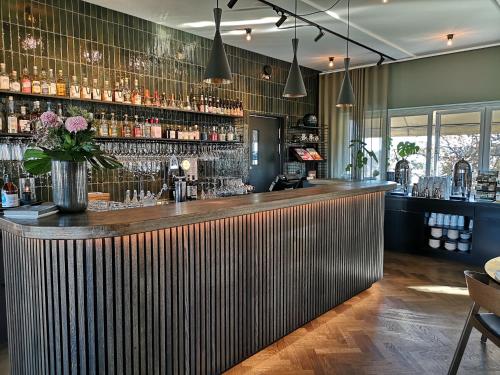 a bar in a restaurant with a wooden counter at Hotell Kristina in Sigtuna
