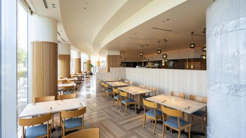 a row of tables and chairs in a restaurant at JR Hotel Clement Takamatsu in Takamatsu