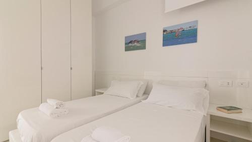 Ένα ή περισσότερα κρεβάτια σε δωμάτιο στο Rivazzurra Homes - C