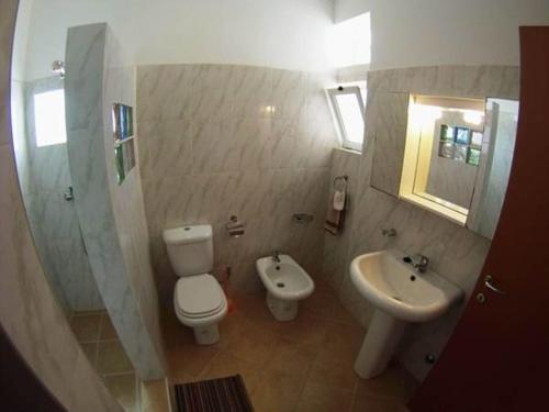 a bathroom with a toilet and a sink at Casa Bahia 8 in Santa Maria