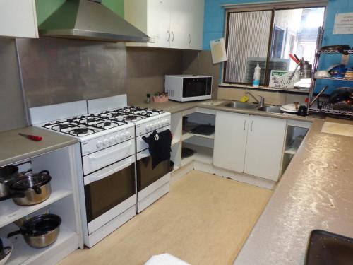a kitchen with a stove and a sink at Mildura Stopover in Mildura