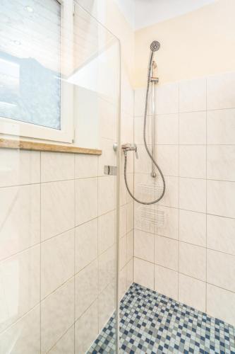 a bathroom with a shower with a glass door at Gästehaus Kochelsee in Kochel